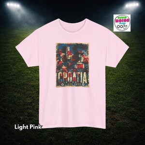 Light pink Croatia football tee with faded red white and blue colours, distressed retro football lettering and summer 2026 tournament energy.