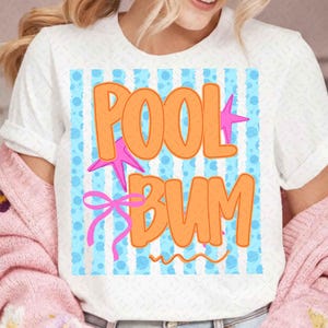 May include: A white short-sleeve t-shirt featuring a graphic print with light blue vertical stripes and blue polka dots. The text POOL BUM is written in large orange letters, accented by two pink starfish and a pink ribbon bow graphic.