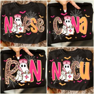 May include: Black long-sleeve shirts with Halloween-themed designs. Each shirt features a ghost nurse character holding a medical bag, with text spelling out "Nurse," "CNA," "RN," and "NICU." The designs include spiderwebs, bats, and pink and orange accents.