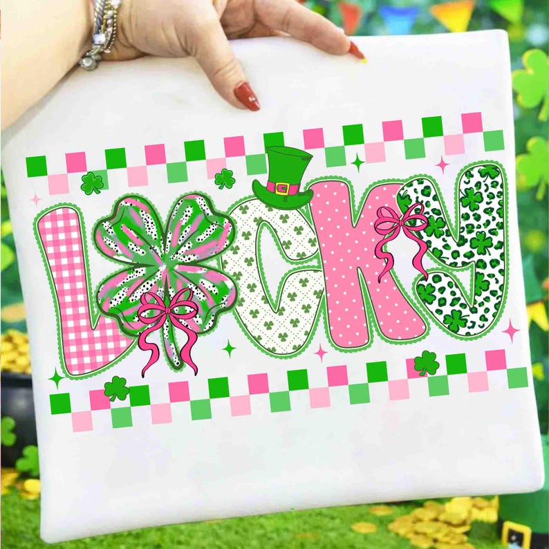 May include: White St. Patrick's Day themed design with the word "LUCKY" in pink, green, and white. The letter "L" is pink gingham, the "U" is a green shamrock, the "C" is white with green shamrocks, the "K" is pink, and the "Y" is green leopard print.
