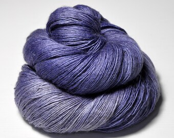 May include: A skein of purple and white yarn with a gradient effect. The yarn is soft and fluffy, and it is perfect for knitting or crocheting.