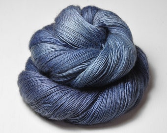 May include: A skein of blue yarn with a gradient of color from light to dark blue.