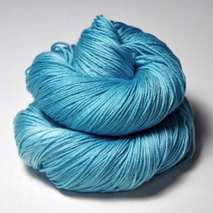 May include: A skein of light blue yarn, wound into a ball shape.