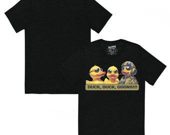 May include: Black t-shirt with a graphic of three cartoon ducks wearing sunglasses and military gear. The text "DUCK, DUCK, GOONS!!!" is below the ducks. The back of the shirt is also visible.