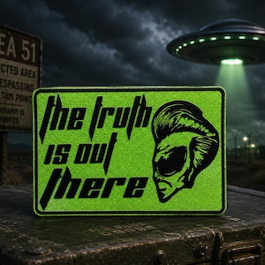 May include: A rectangular patch with a bright lime green background and a black border. The text "the truth is out there" is printed in a bold black font on the left side, accompanied by a black graphic illustration of an alien head on the right.
