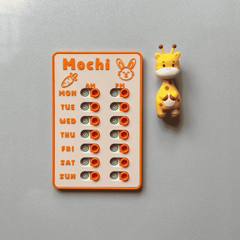 May include: A yellow and orange weekly planner with a giraffe-shaped magnet. The planner has the word "Mochi" at the top, with a carrot and bunny illustration. The days of the week are listed, with AM and PM indicators.