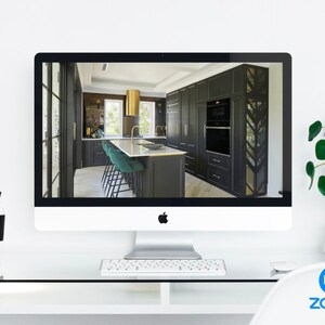May include: A computer screen displaying a modern kitchen with black cabinets, gold hardware, and a green island with bar stools. The screen is on a white desk with a keyboard, mouse, and a Zoom logo.