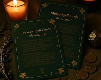 May include: Two dark green Money Spell Cards with gold floral accents and text. The cards are titled "Money Spell Cards: Abundance." A lit candle in a glass holder and three coins are also visible.