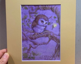 May include: A framed watercolor painting of a small owl perched on a tree branch. The owl has brown and purple feathers and large eyes. The background is a deep purple with green leaves and a glowing insect. The artwork is signed by the artist.