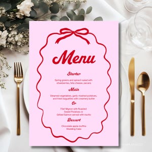 May include: A light pink menu card featuring a red scalloped border and a red bow at the top. The text reads Menu, Starter, Spring greens and spinach salad with strawberries, feta cheese, pecans, Main, Steamed vegetables, garlic mashed potatoes, and fresh baguettes with creamery butter, Or, Filet Mignon with Roasted Sweet Potatoes or Grilled Salmon served with risotto, Dessert, Chocolate apple muffins, Wedding Cake.