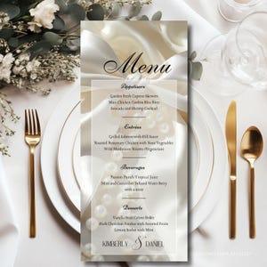 May include: A wedding menu card with a white background and elegant script. The menu lists appetizers, entrées, beverages, and desserts. Gold cutlery and a white plate are on the right. The menu is personalized with the names Kimberly & Daniel.
