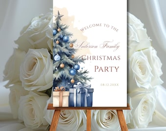 May include: A Christmas party welcome sign on a wooden easel. The sign features a watercolor illustration of a Christmas tree with blue ornaments and gifts. Text reads "Welcome to the Anderson Family Christmas Party" and the date.