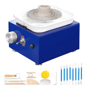 May include: A blue pottery wheel with a white tray and a gray ceramic piece on top. The wheel has a silver knob and an on/off switch. Included are various pottery tools with wooden handles and blue plastic handles, along with a yellow sponge.