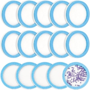 May include: A collection of circular filters with a white center and a light blue border. One filter contains small purple beads. The filters are arranged in three rows, with the top two rows containing five filters each and the bottom row containing four filters.