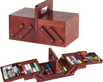 May include: A wooden sewing box with a handle, shown closed and open. The closed box is a dark brown with a rectangular shape. The open box reveals compartments filled with spools of thread in various colors, needles, and other sewing supplies.