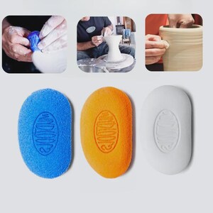 May include: Three pottery sponges in blue, orange, and white, each with an oval shape and a textured surface. The sponges have a stamped design. The image also shows hands working with clay and a pottery wheel.