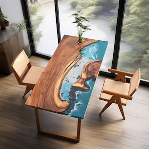 May include: A rectangular wooden table with a blue epoxy resin design resembling a coastal scene. The table is supported by a light brown wooden frame. Two wooden chairs with woven seats are positioned on either side of the table.