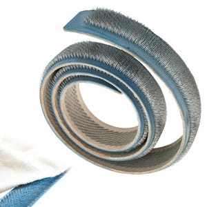 May include: A coiled roll of blue and gray carpet tack strip with metal pins. The strip is designed to hold carpet in place. The image shows the tack strip against a white background.