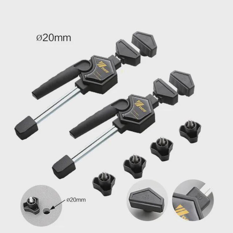 a pair of black and gold clamping tools with adjustable handles, designed for use in various applications.