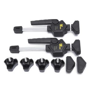 a pair of black clamping tools with various black plastic parts, including hexagonal components, arranged on a white background.