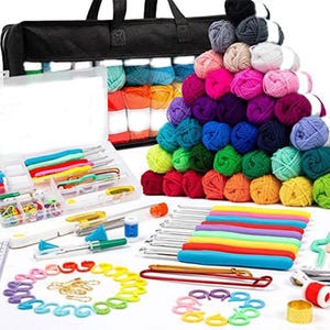 May include: A comprehensive crochet kit featuring a black tote bag, colorful yarn balls, crochet hooks, stitch markers, and various crafting tools. The yarn is arranged in a vibrant array of colors, including pink, purple, blue, green, and yellow. The kit is designed for crochet enthusiasts.
