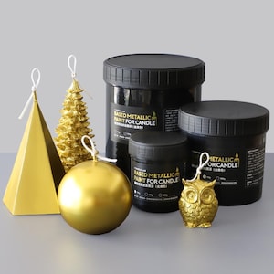 May include: A collection of gold-colored candle molds and black containers of metallic paint. The molds include a pyramid, Christmas tree, sphere, and owl. The containers are labeled "BASED METALLIC PAINT FOR CANDLE".