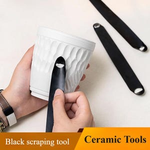 May include: A white ceramic pot with a textured, geometric pattern is being worked on with a black scraping tool. Two additional black scraping tools are visible. The text "Black scraping tool" and "Ceramic Tools" are at the bottom.