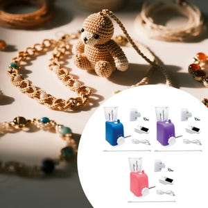 May include: A collection of handmade jewelry and a small crocheted teddy bear. The jewelry includes a necklace and bracelet with gold and gemstone accents. Three miniature blenders in blue, purple, and pink are also visible.
