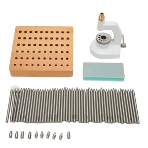May include: A watch repair kit featuring a white watch holder, a wooden block with various sized holes, a green and white abrasive block, and a set of silver tools. The kit is designed for watch repair and maintenance.