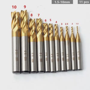 May include: A set of 11 gold and silver HSS drill bits, ranging from 1.5mm to 10mm. Each bit is labeled with its size and "HSS". The bits are arranged in ascending order, with the largest bit labeled "10" and the smallest "1.5".
