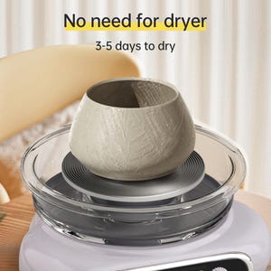 May include: A light gray, textured ceramic pot sits on a clear glass dish, atop a white base. The text "No need for dryer" and "3-5 days to dry" are displayed in yellow and black, respectively. The pot has a wide opening and a rounded shape.