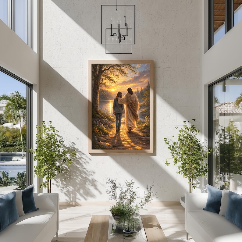 May include: A framed artwork depicts two figures walking along a path towards a sunset over a lake. The figures are bathed in warm light, with a detailed landscape of trees and water. The artwork is displayed in a modern living room setting.