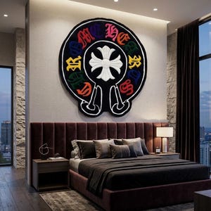 May include: A large circular wall rug featuring a black background with a white cross emblem in the centre. The text CHROME HEARTS is embroidered in a gothic font around the emblem in alternating colours of red, blue, yellow, green, and pink.