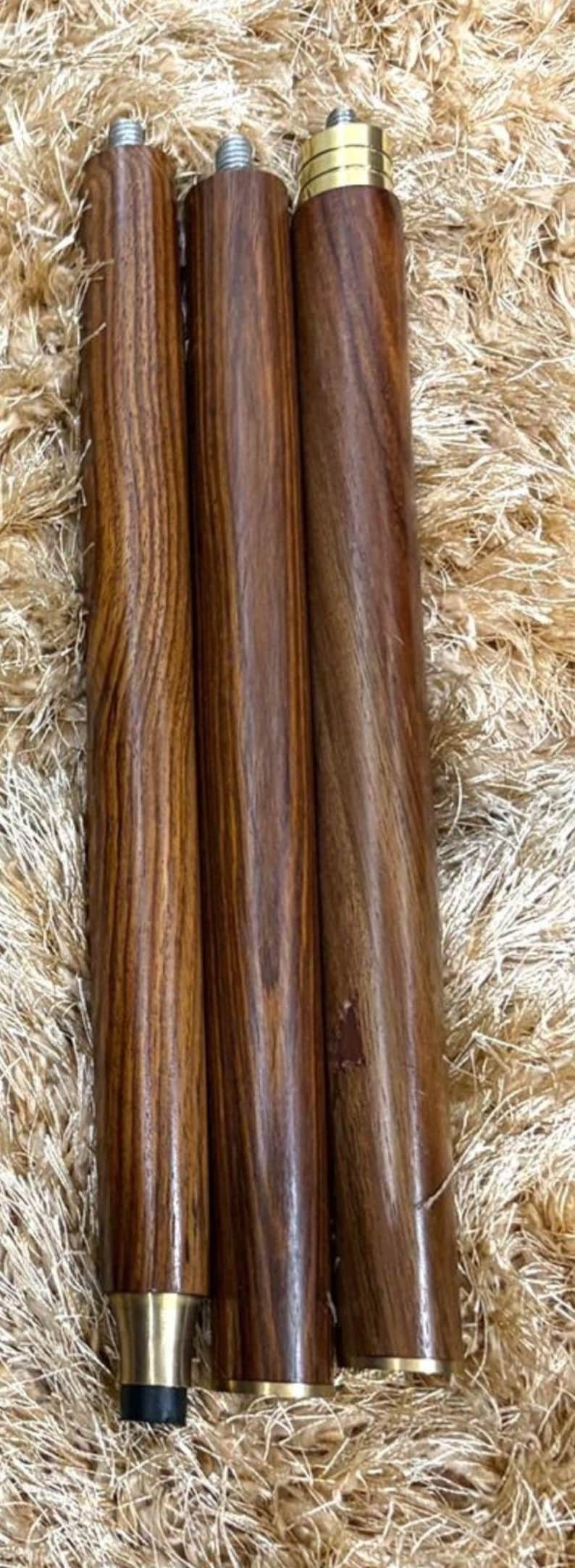 May include: Three wooden furniture legs with a rich, dark brown grain. The legs have brass-colored accents at the base and top, and are designed for furniture. The legs are approximately 12 inches tall.