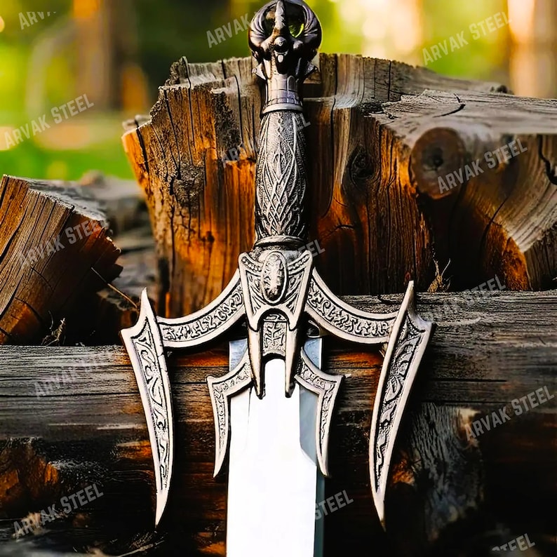 May include: A detailed close-up of a decorative sword with an ornate handle and blade. The sword features intricate carvings and a silver finish. The blade is sharp and polished, reflecting the light. The sword is set against a wooden background.