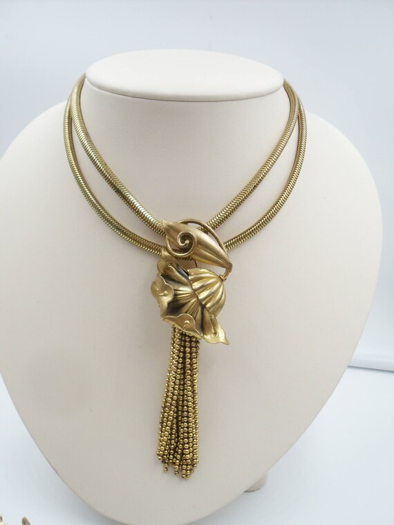 Thirties era brass flower brooch with cascading ch