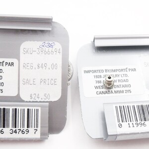May include: Two grey rectangular earring display cards featuring white labels with black text. The labels include the text IMPORTED BY/IMPORT&Eacute; PAR 1928 JEWELRY LTD. 788 ARROW ROAD WESTON, ONTARIO CANADA M9M 2Y5, SKU-3966694, and a barcode at the bottom.