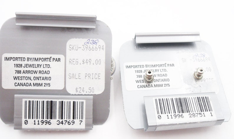 May include: Two grey rectangular earring display cards featuring white labels with black text. The labels include the text IMPORTED BY/IMPORT&Eacute; PAR 1928 JEWELRY LTD. 788 ARROW ROAD WESTON, ONTARIO CANADA M9M 2Y5, SKU-3966694, and a barcode at the bottom.