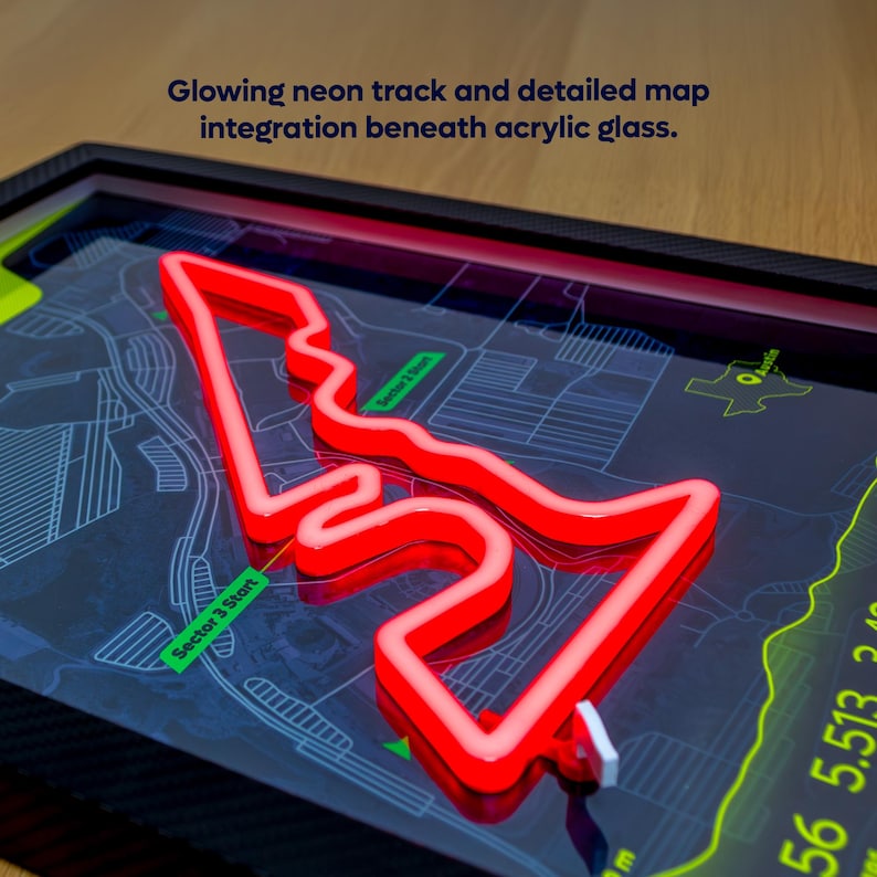Close-up detail of the Austin Neon F1 Track Poster featuring the United States Grand Prix circuit in Austin, Texas. A raised red LED-style track outline representing Charles Leclerc’s Ferrari fastest lap glows beneath clear acrylic glass, layered over a detailed map background with sector markers and circuit information. The framed motorsport wall art highlights the 3D neon effect and premium construction.