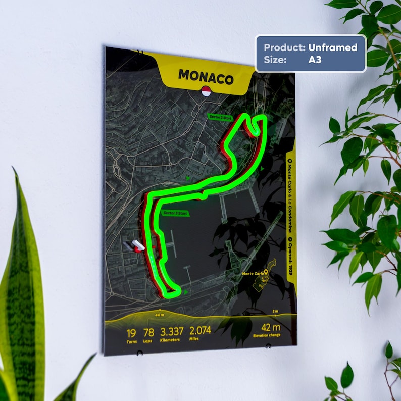 May include: An unframed A3 poster featuring a dark map of the Monaco Grand Prix circuit. A bright neon green line traces the track layout over the street grid. Text includes MONACO, 19 turns, 78 laps, 3.337 kilometers, 2.074 miles, and 42 m elevation change.