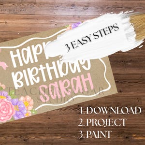 May include: A brown paper sign with the words "Happy Birthday Sarah" in white and pink lettering, decorated with floral accents. The sign also includes the text "3 EASY STEPS" and instructions: "1. DOWNLOAD 2. PROJECT 3. PAINT."