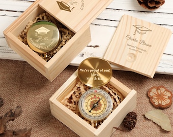 May include: Wooden boxes with engraved compasses, ideal for graduation gifts. One box features a compass with "Bella 2026 Congratulations" engraved. Another compass reads "We're proud of you! Love, Mom & Dad."