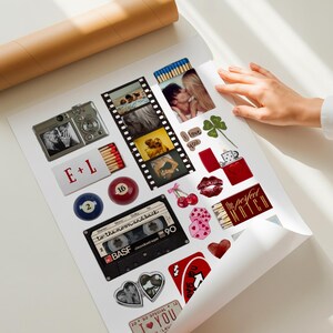 May include: A white poster featuring a collage of various illustrations and photographs, including a digital camera, a film strip, a cassette tape labeled BASF, billiard balls, dice, cherries, a red lighter, and matchboxes with the text E+L and The Perfect Match.
