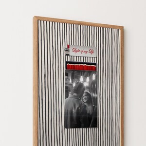 May include: A framed artwork featuring a black and white photo of a couple. The frame has a striped background and a wooden border. Above the photo is a metal piece with the text "Light of my Life" in red.