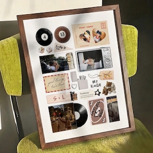 May include: A framed collage featuring various items, including a black 8-ball, a brown 12-ball, dice, a postcard with heart-shaped photos, a digital camera, a lighter, a vinyl record, and a teddy bear. The collage includes the text "lucky me", "good things take time", "S + L", and "My Love".