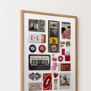 May include: A framed collage print featuring various nostalgic items including a silver camera, a film strip with photos, a matchbox labeled E+L, billiard balls, a black BASF cassette tape, red cherries, dice, a red lighter, and a red playing card.
