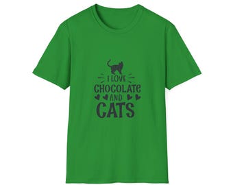 May include: A green t-shirt with the text "I LOVE CHOCOLATE AND CATS" in a dark blue font. The design includes a cat silhouette and heart shapes. The shirt is a short-sleeved crew neck.