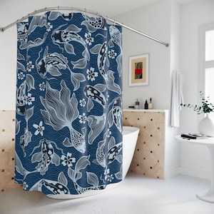May include: A navy blue shower curtain featuring a repeating pattern of koi fish and floral elements in white. The design includes stylized waves, creating a serene and aquatic theme. The curtain is hanging in a bathroom setting.