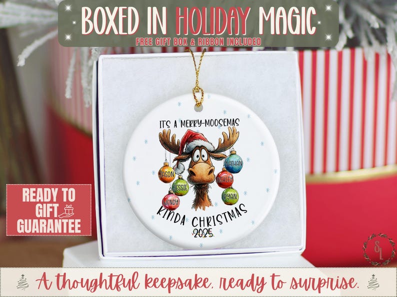 May include: A white ceramic Christmas ornament featuring a cartoon moose wearing a Santa hat. The ornament reads "It's a Merry-Moosemas Kinda Christmas 2025" with personalized names on the hanging ornaments. The ornament is in a gift box.
