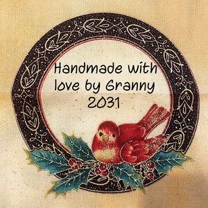 May include: Circular handmade label with a red bird, holly leaves, and berries. The label has the text "Handmade with love by Granny 2031" in black font, surrounded by a decorative border.